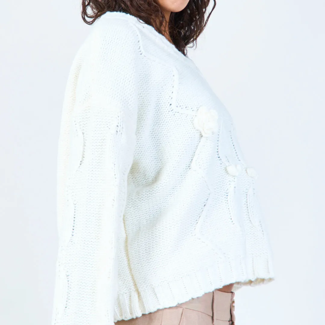 Textured cable knit sweater with floral detail wholesale