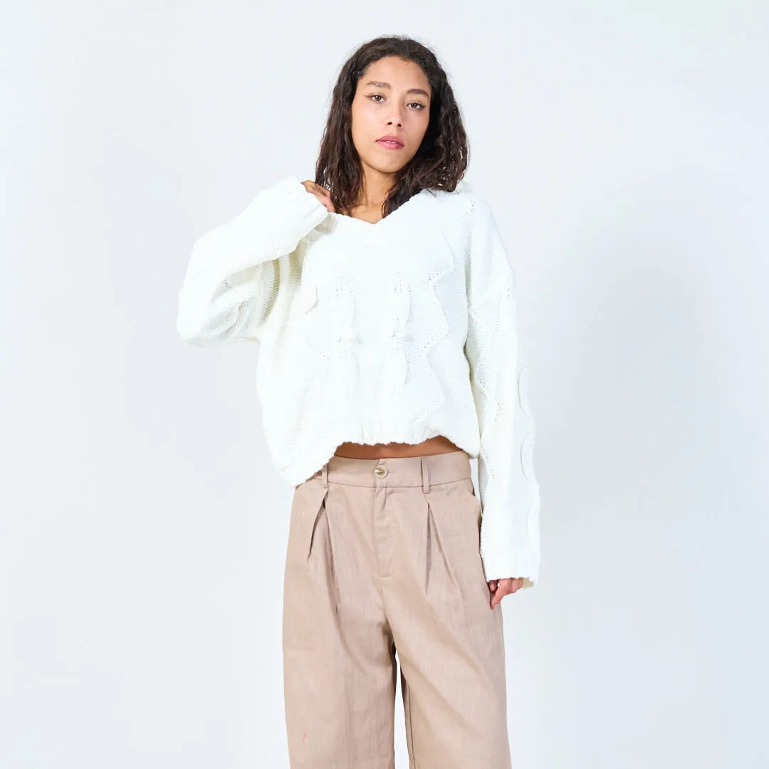 Textured cable knit sweater with floral detail wholesale